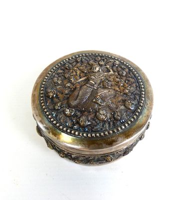 a silver box with a bird on it on a white surface
