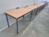 a row of tables in a room with a wall behind them