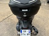 a motorcycle parked in a parking lot with a license plate on the back