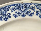 a blue and white plate with a bird on it
