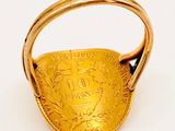 an image of a gold ring with a coin in the middle