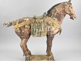 statue of a horse with a saddle on it ' s back and a saddle on its back