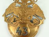 an image of a gold plate with an eagle on top of it
