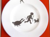 a plate with a picture of a man and a dog on it