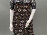a mannequin wearing a black dress with a floral pattern