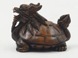 wooden figurine of a turtle with a dragon on it ' s back