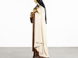 a statue of a woman in a white robe holding a cat
