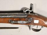 an old rifle with a wooden barrel and a metal handle