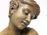 a bronze statue of a woman with her eyes closed