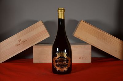 a bottle of wine sitting on a table next to two wooden boxes
