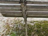 a wooden bench that is sitting in the grass