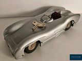a silver toy car with a bunch of keys in it