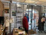 an image of a clothing store with clothes on display