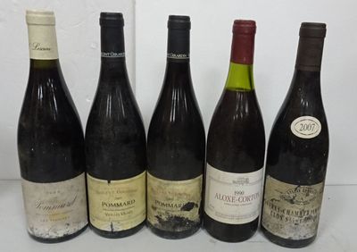 six bottles of wine are lined up on a table