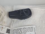 a black remote control sitting on top of a white towel