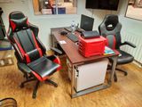 a desk with two chairs and a computer on top of it
