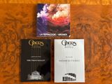three books are sitting on a table next to each other
