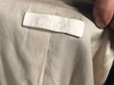 someone is holding a label on a shirt that says
