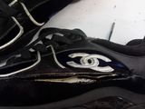 a pair of black shoes with a silver eye on them