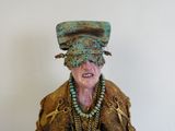 une statue représentant une femme portant un chapeau et des colliers