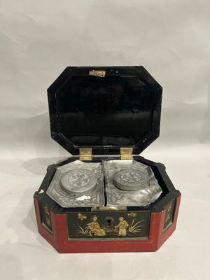 a black and red box with two glasses in it on a white surface