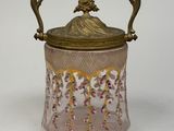 an image of a pink glass jar with a gold lid
