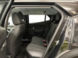 the back seats of a car with the door open in a car showroom
