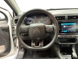 the interior of a car with a steering wheel and dashboard controls