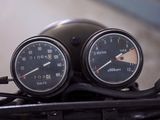 two speedometers on the handlebars of a motorcycle
