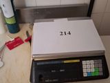 a picture of a counter top with a scale and a bottle of wine on it