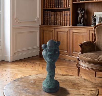 a blue vase sitting on a table in a living room