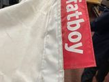 a white bag with a red tag on it