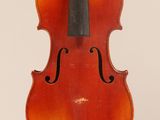 an old violin with a bow hanging from the back
