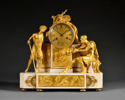 a gold clock sitting on top of a marble table