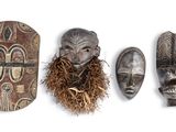 several african masks are lined up against a white background
