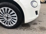 a close up of a tire on a car in a parking lot