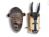 pair of african masks with horns on each side of each other