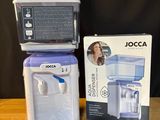a box with a water dispenser next to a box of soap