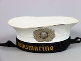a white hat with a black ribbon around it