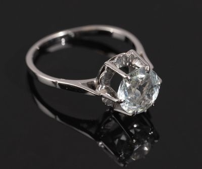 a close up of a diamond ring on a black surface