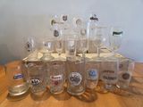 a lot of beer glasses sitting on a table