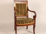 a wooden chair with striped upholstered seat and arms
