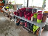 many pots and bowls on a table in a room