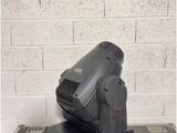 a close up of a moving light on a table near a brick wall