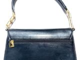 a black purse with a gold clasp on it