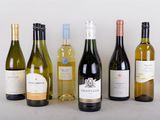 several bottles of wine are lined up in a row on a table