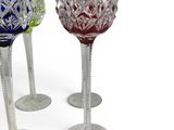 three wine glasses sitting next to each other on a white surface
