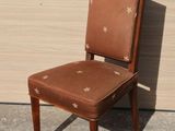 a brown chair with stars on it sitting in front of a wall