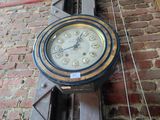 a clock hanging on the side of a brick wall