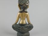 an image of a statue of a woman sitting in a lotus position